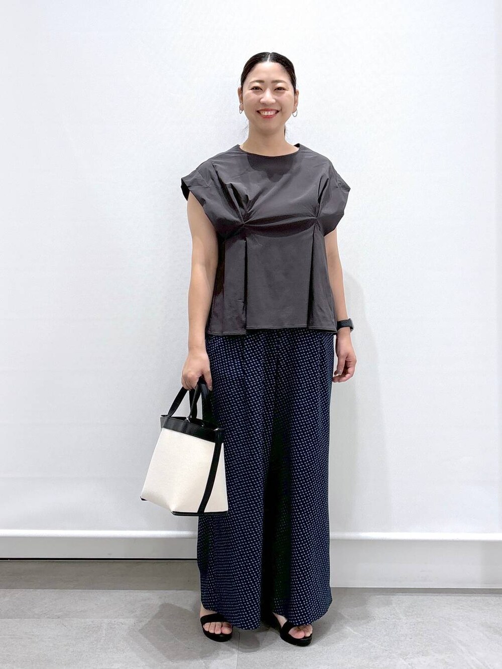 ブラック系のトートバッグ、グレー系のシャツ/ブラウス、ブルー系のその他パンツを着用したレディースの夏コーディネートの2枚目の写真