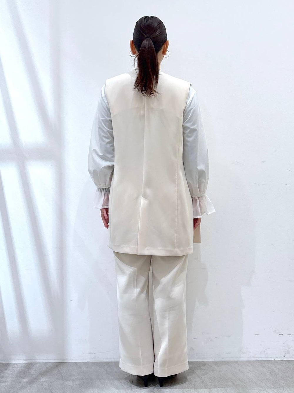 ホワイト系のその他パンツ、ホワイト系のスーツベスト、ホワイト系のシャツ/ブラウスを着用したレディースの冬コーディネートの4枚目の写真