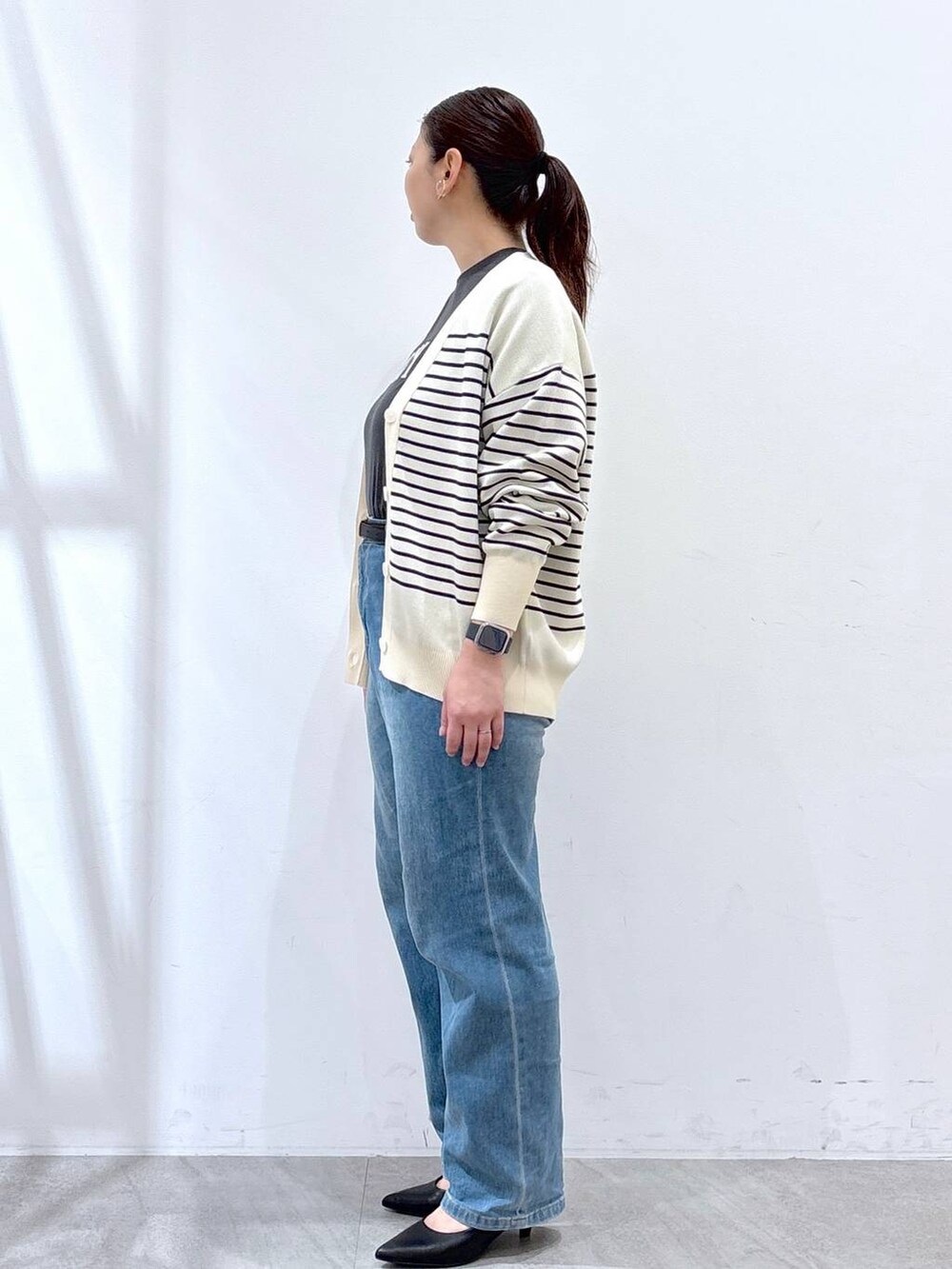 ブルー系のデニムパンツ、ブルー系のカーディガン/ボレロ、グレー系のTシャツ/カットソーを着用したレディースの春コーディネートの3枚目の写真