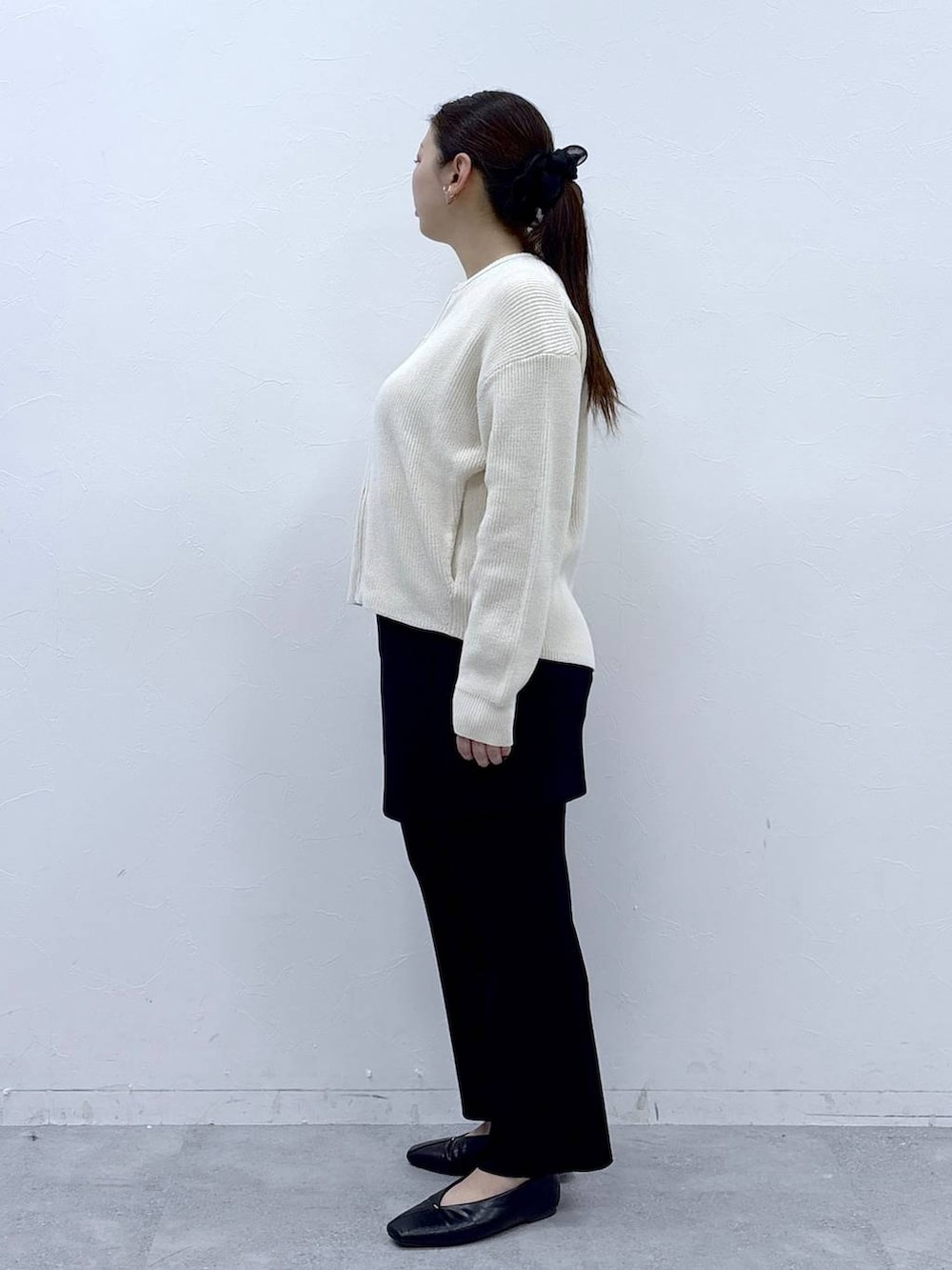 ブラック系のハンドバッグ、ブラック系のパンプス、ブラック系のその他パンツを着用したレディースの春コーディネートの3枚目の写真