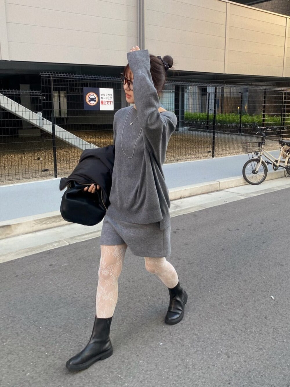 グレー系のスカート、グレー系のニット/セーターを着用したレディースの秋コーディネートの2枚目の写真