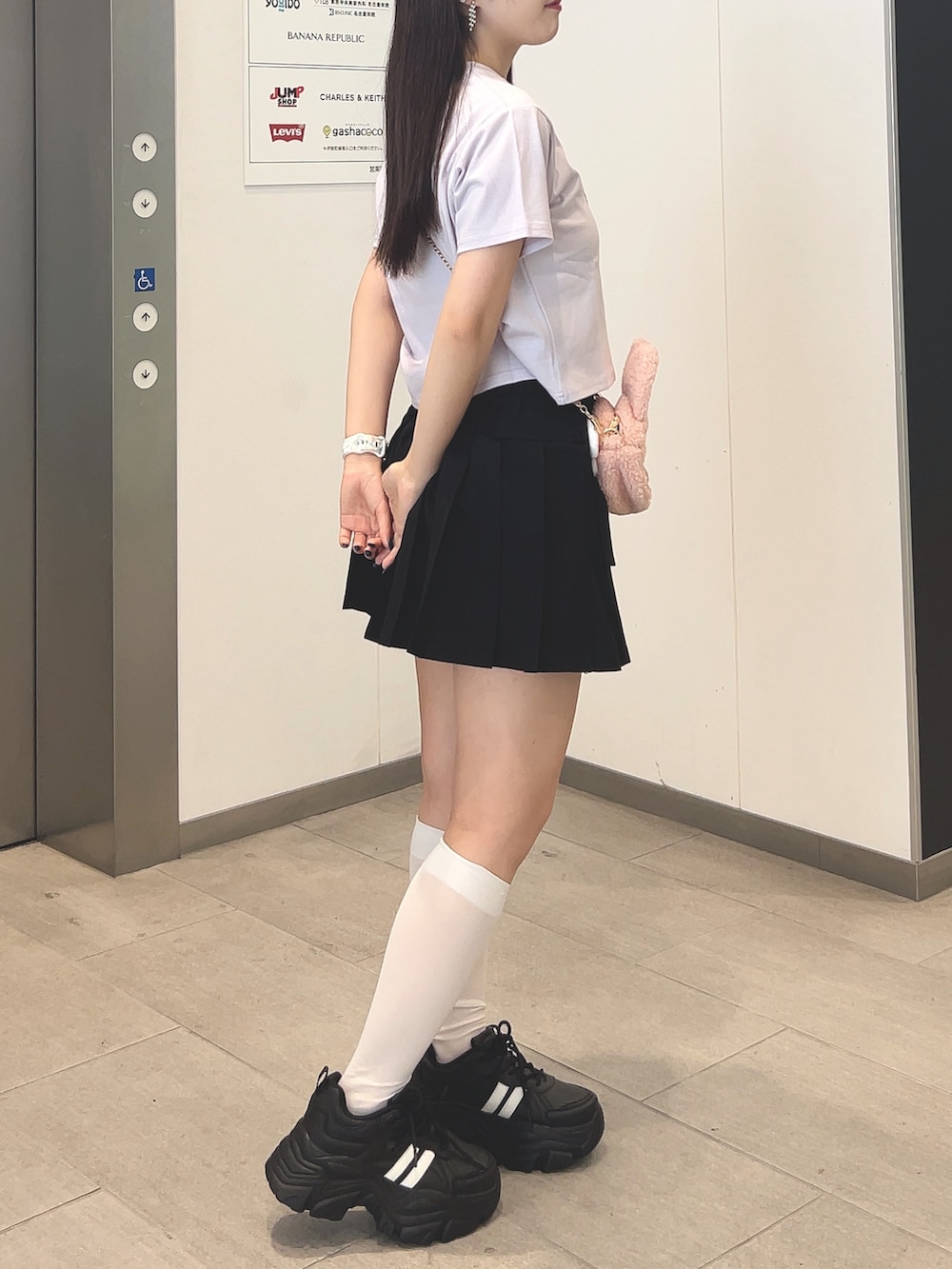 パープル系のTシャツ/カットソー、ブラック系のスカート、ブラック系のその他シューズを着用したレディースの夏コーディネートの2枚目の写真