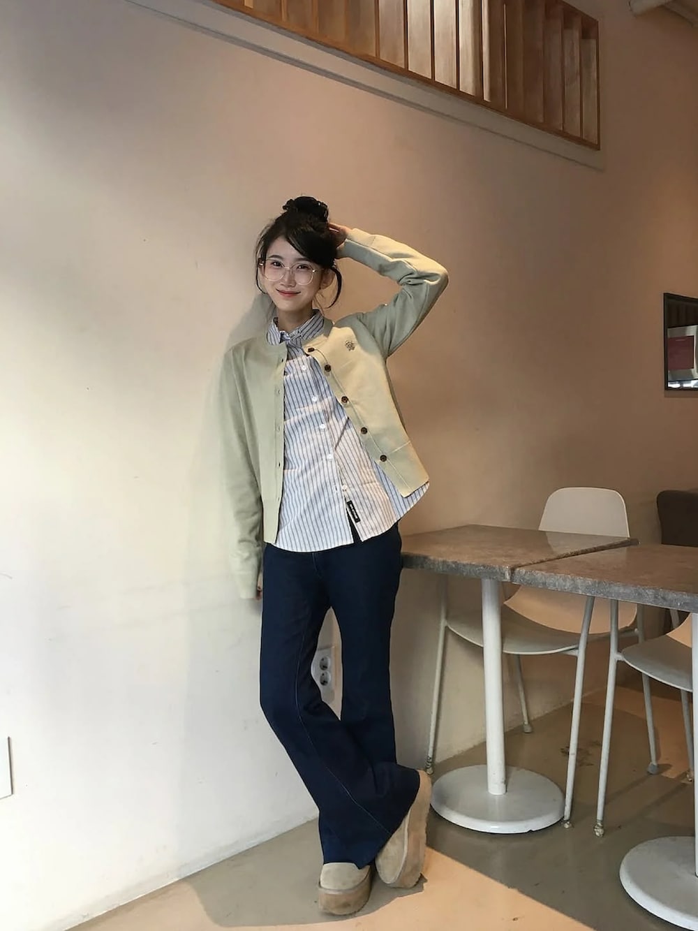 グレー系のトップス、グリーン系のカーディガン/ボレロを着用したレディースの冬コーディネートの2枚目の写真