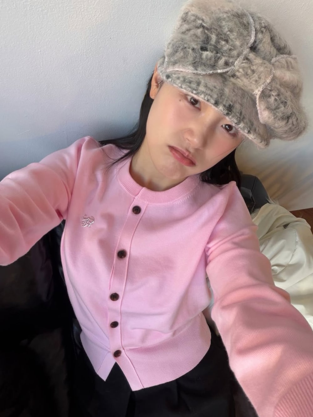 ピンク系のカーディガン/ボレロを着用したレディースの冬コーディネートの2枚目の写真