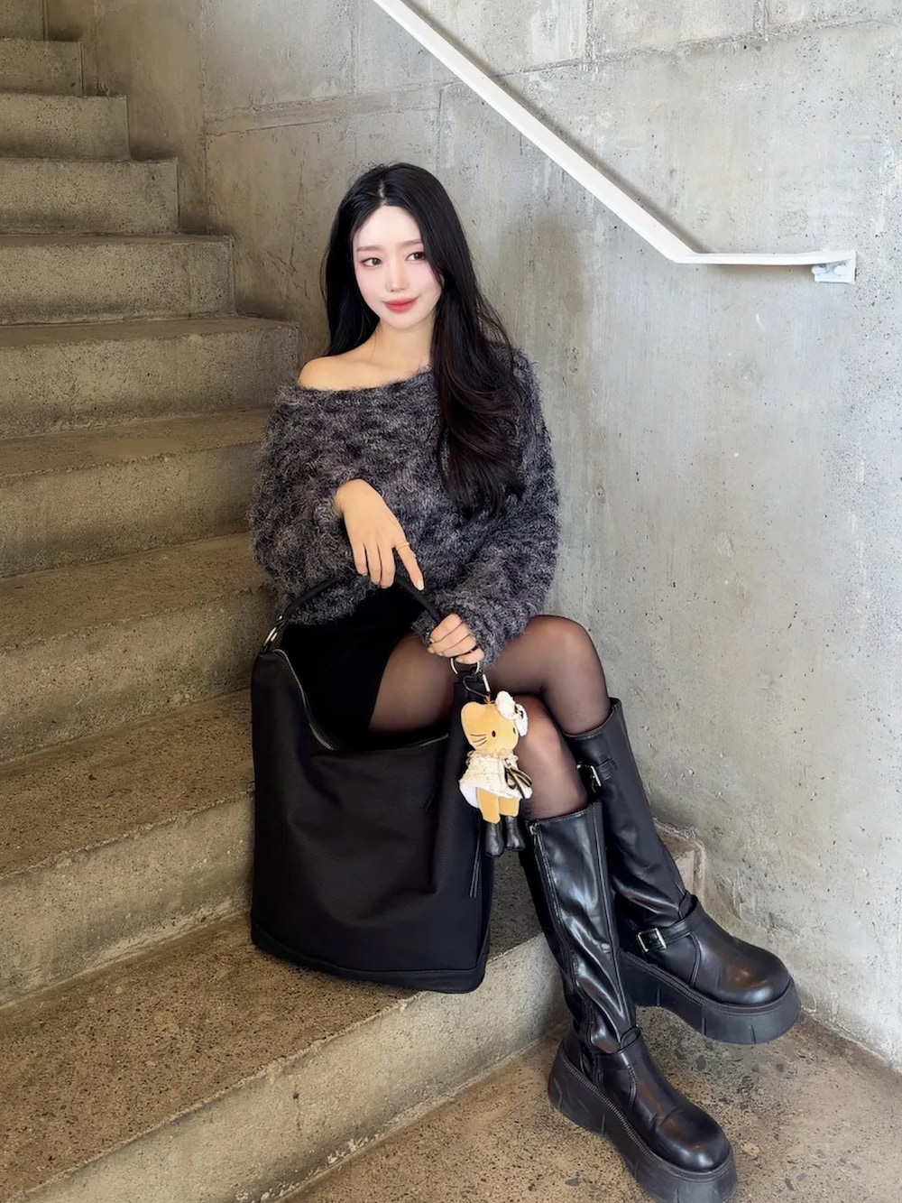 ブラウン系のショルダーバッグを着用したレディースの冬コーディネートの2枚目の写真