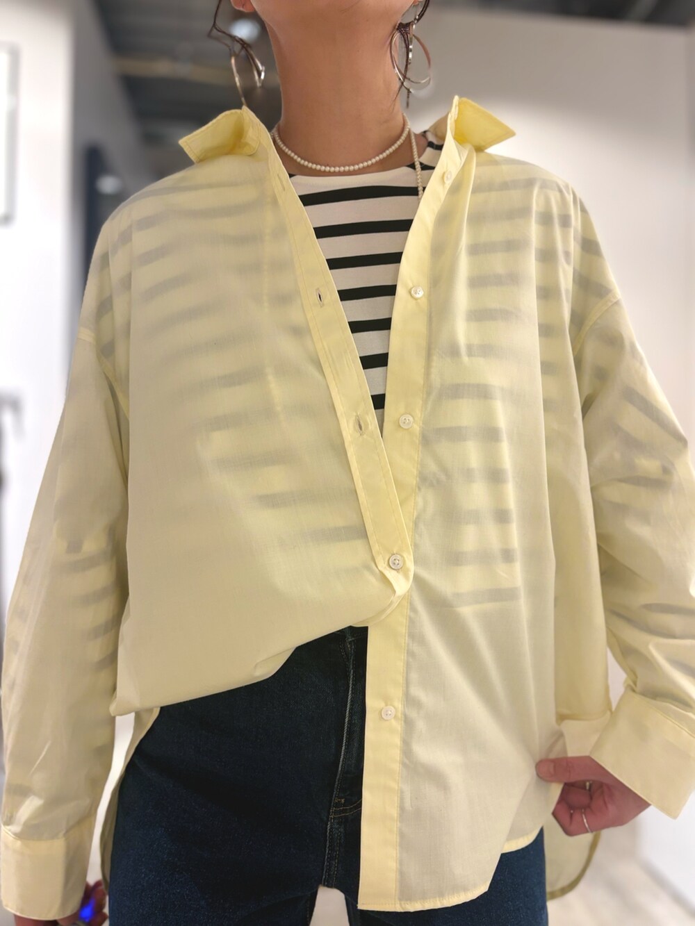 ブルー系のデニムパンツ、ホワイト系のTシャツ/カットソー、ベージュ系のシャツ/ブラウスを着用したレディースの冬コーディネートの4枚目の写真