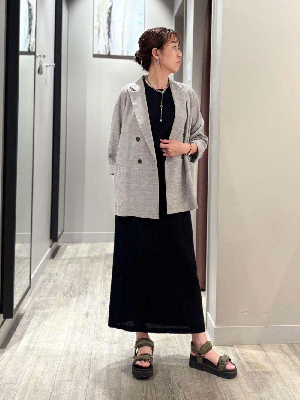 ブラック系のシャツ/ブラウス、ブラック系のスカート、グレー系のテーラードジャケットを着用したレディースの夏コーディネートの5枚目の写真