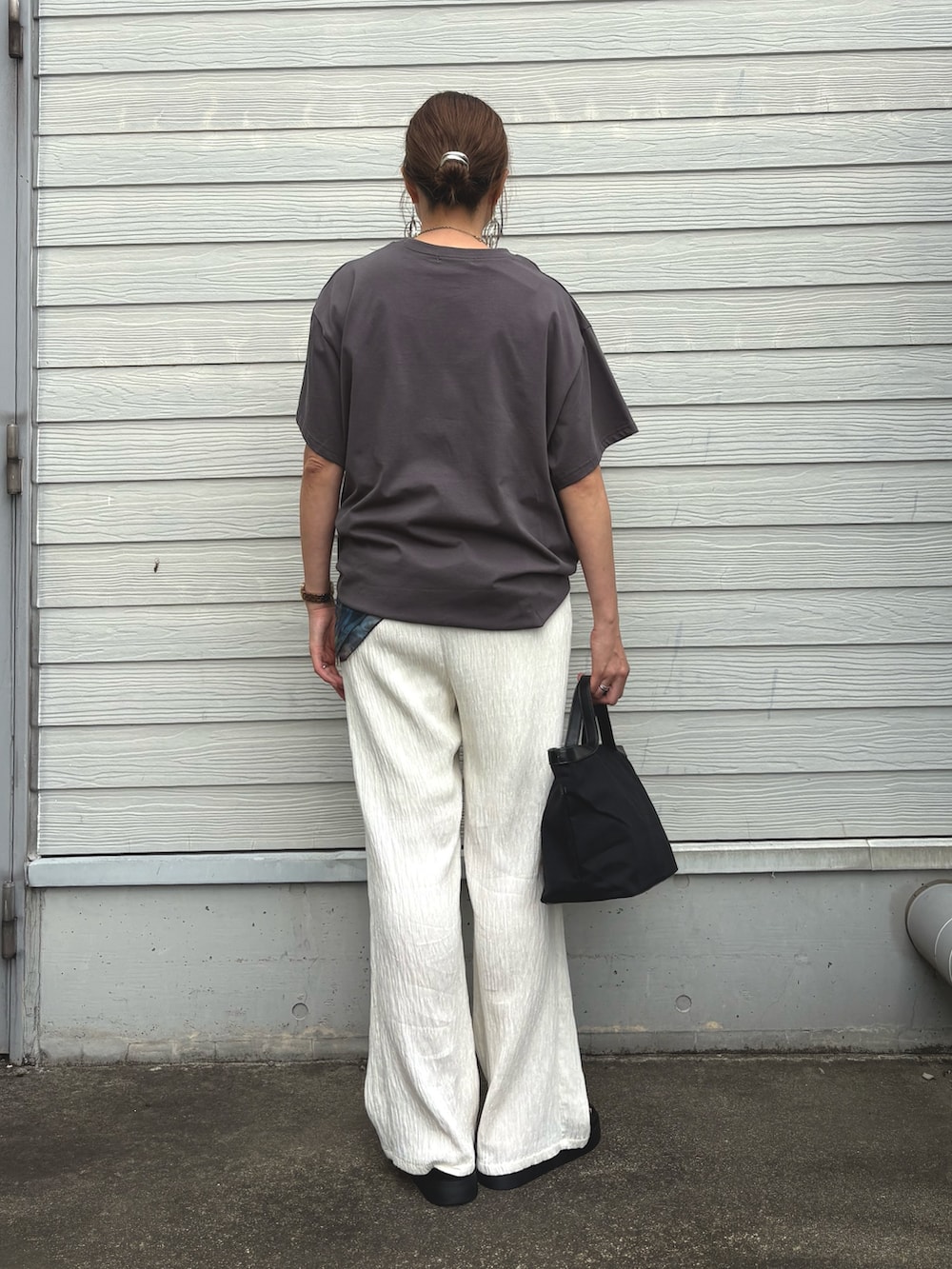 グレー系のTシャツ/カットソー、ホワイト系のその他パンツ、ブラック系のトートバッグを着用したレディースの夏コーディネートの3枚目の写真