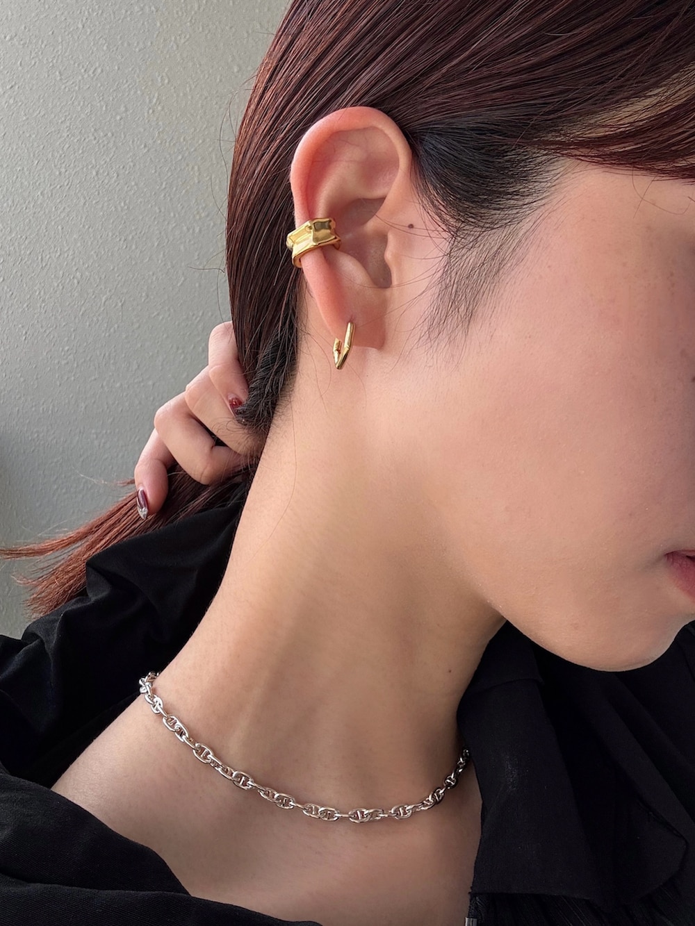 ホワイト系のイヤーカフ、ゴールド系のピアス（両耳用）、シルバー系のネックレスを着用したレディースの秋コーディネートの2枚目の写真