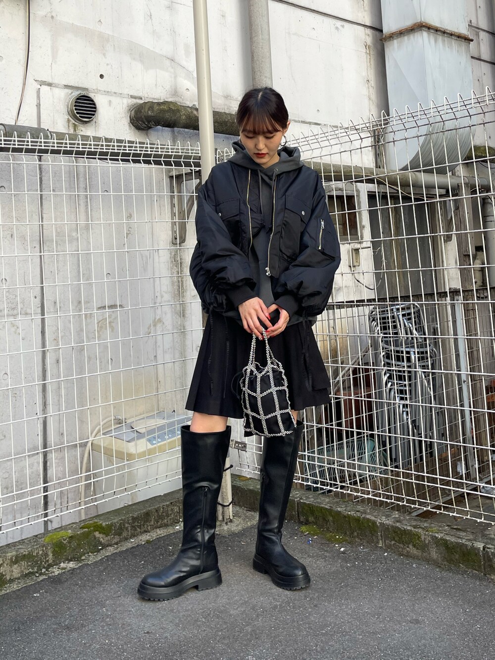 ブラック系のジャケット/アウター、ブラック系のスカート、ブラック系のブーツを着用したレディースの秋コーディネートの2枚目の写真