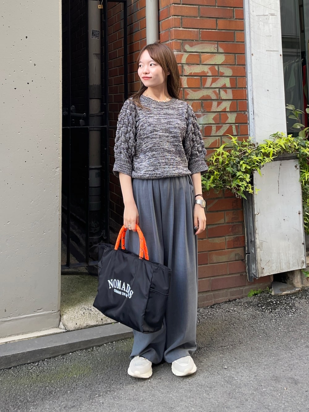 グレー系のニット/セーター、ブラック系のトートバッグ、グレー系のその他パンツを着用したレディースの春コーディネートの7枚目の写真