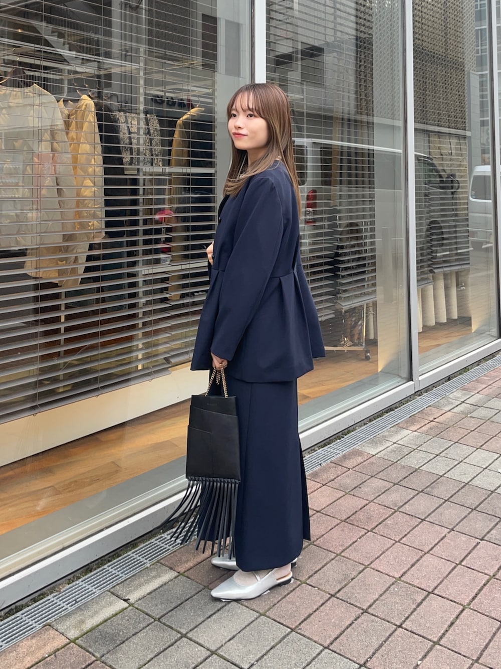 ブルー系のノーカラージャケット、ブルー系のワンピース、シルバー系のパンプスを着用したレディースの冬コーディネートの6枚目の写真