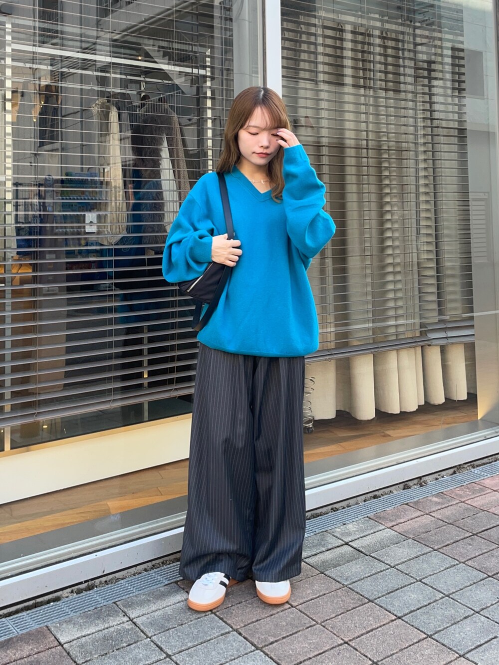その他のその他パンツ、ゴールド系のスニーカー、ブルー系のニット/セーターを着用したレディースの秋コーディネートの6枚目の写真