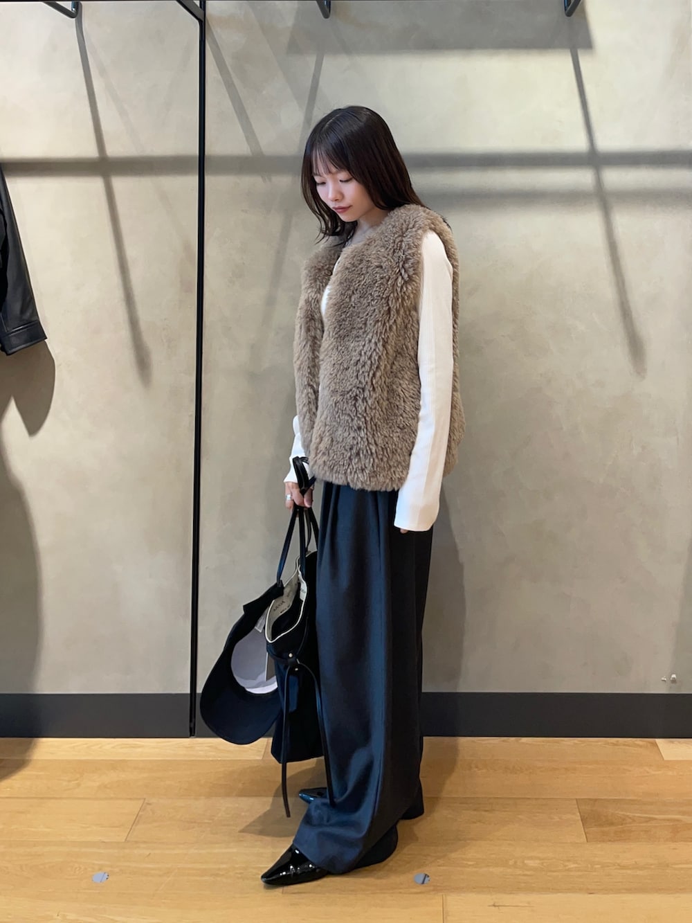 ホワイト系のTシャツ/カットソー、ブラック系のパンプス、ブラック系のトートバッグを着用したレディースの秋コーディネートの3枚目の写真