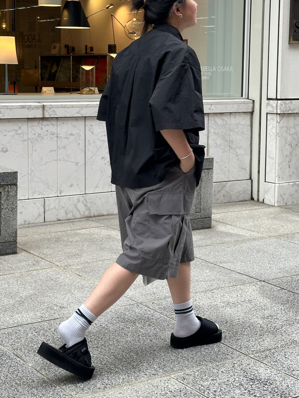 ブラック系のシャツ/ブラウス、グレー系のカーゴパンツ、ブラック系のサンダルを着用したレディースの春コーディネートの2枚目の写真