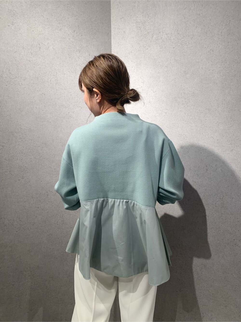 ホワイト系のその他パンツ、ブラック系のブーツ、ブルー系のニット/セーターを着用したレディースの秋コーディネートの3枚目の写真