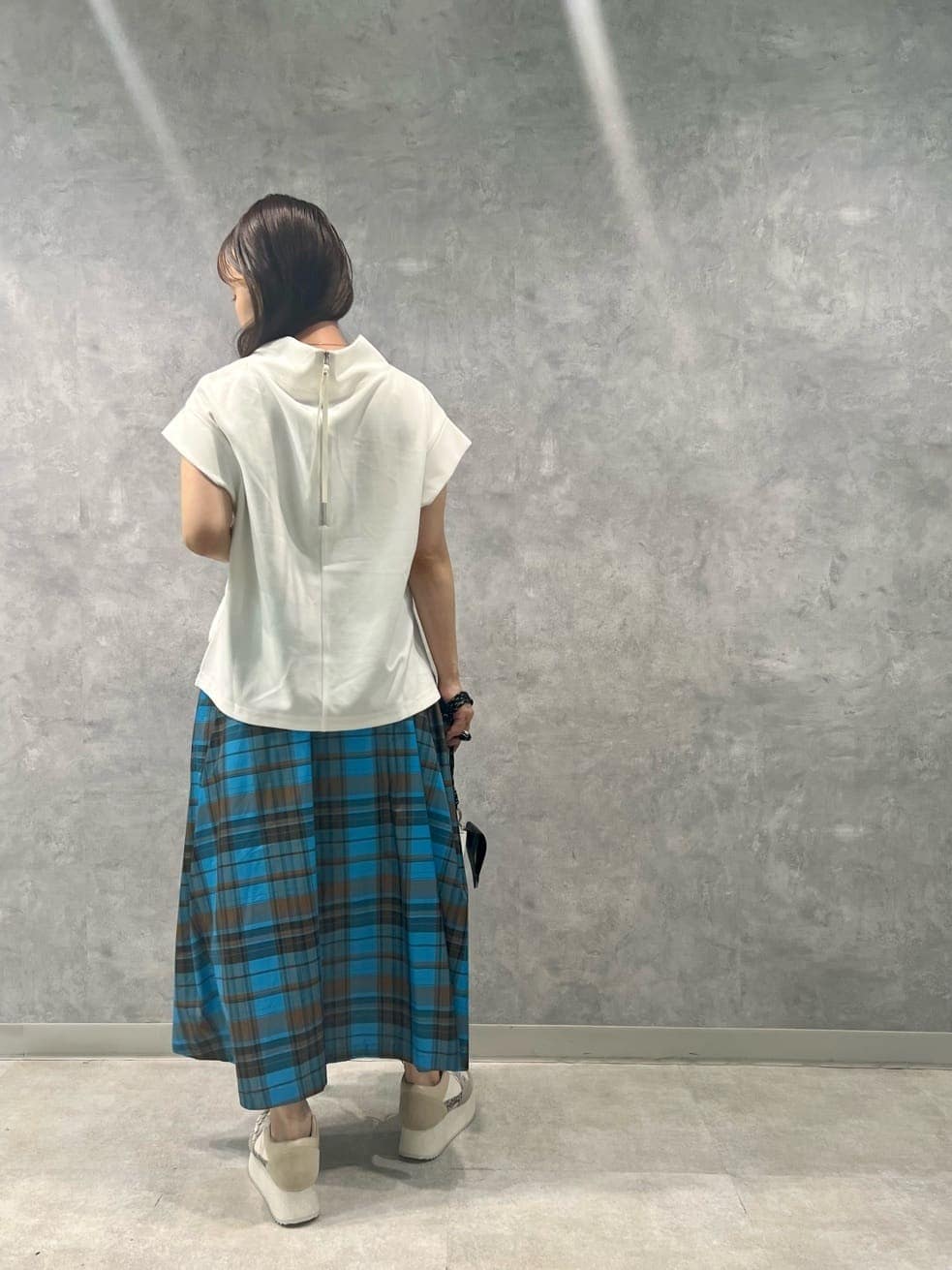 ブラック系のショルダーバッグ、ホワイト系のTシャツ/カットソー、その他のスカートを着用したレディースの夏コーディネートの2枚目の写真