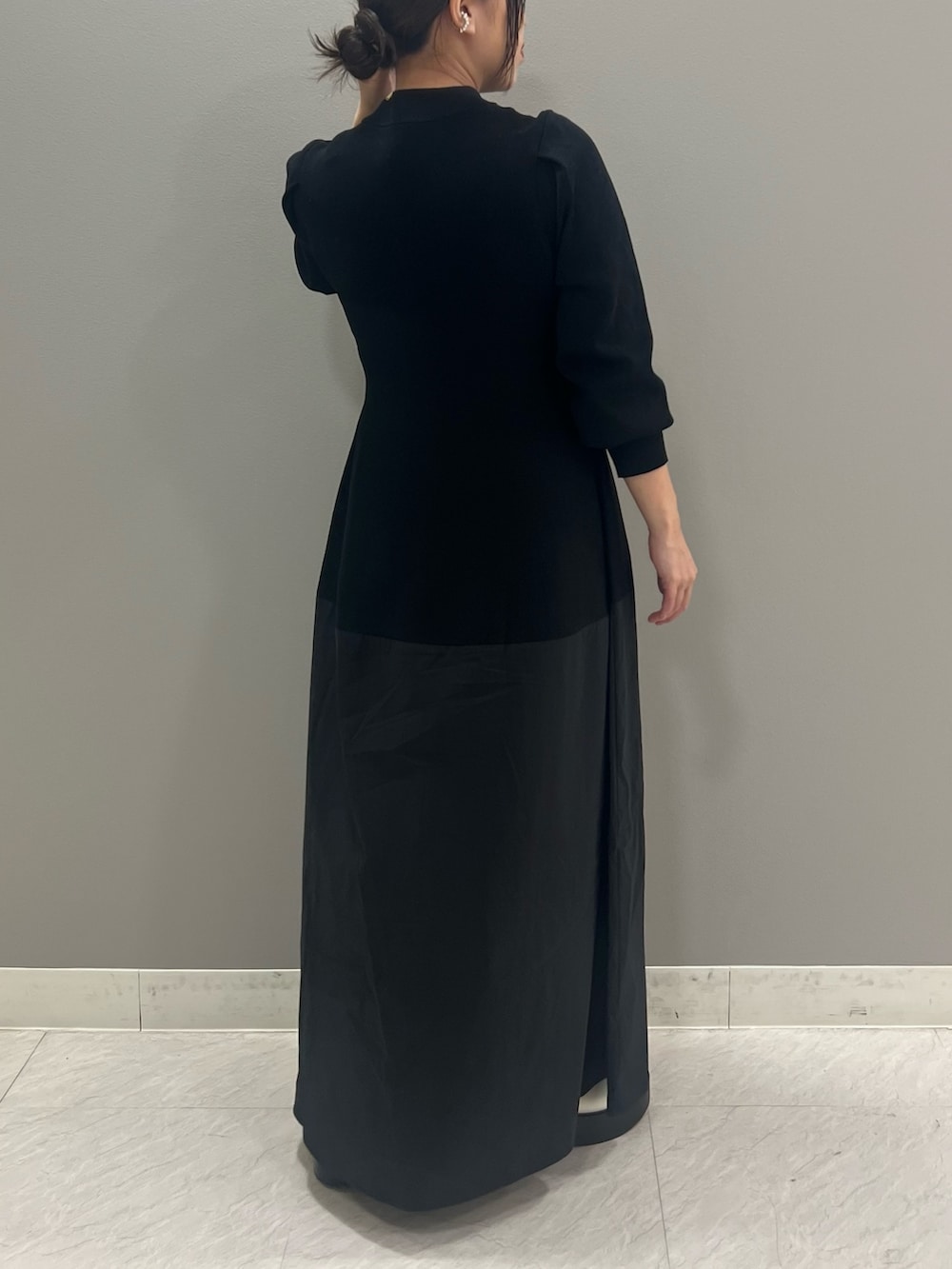 ホワイト系のブーツ、ブラック系のワンピースを着用したレディースの夏コーディネートの2枚目の写真