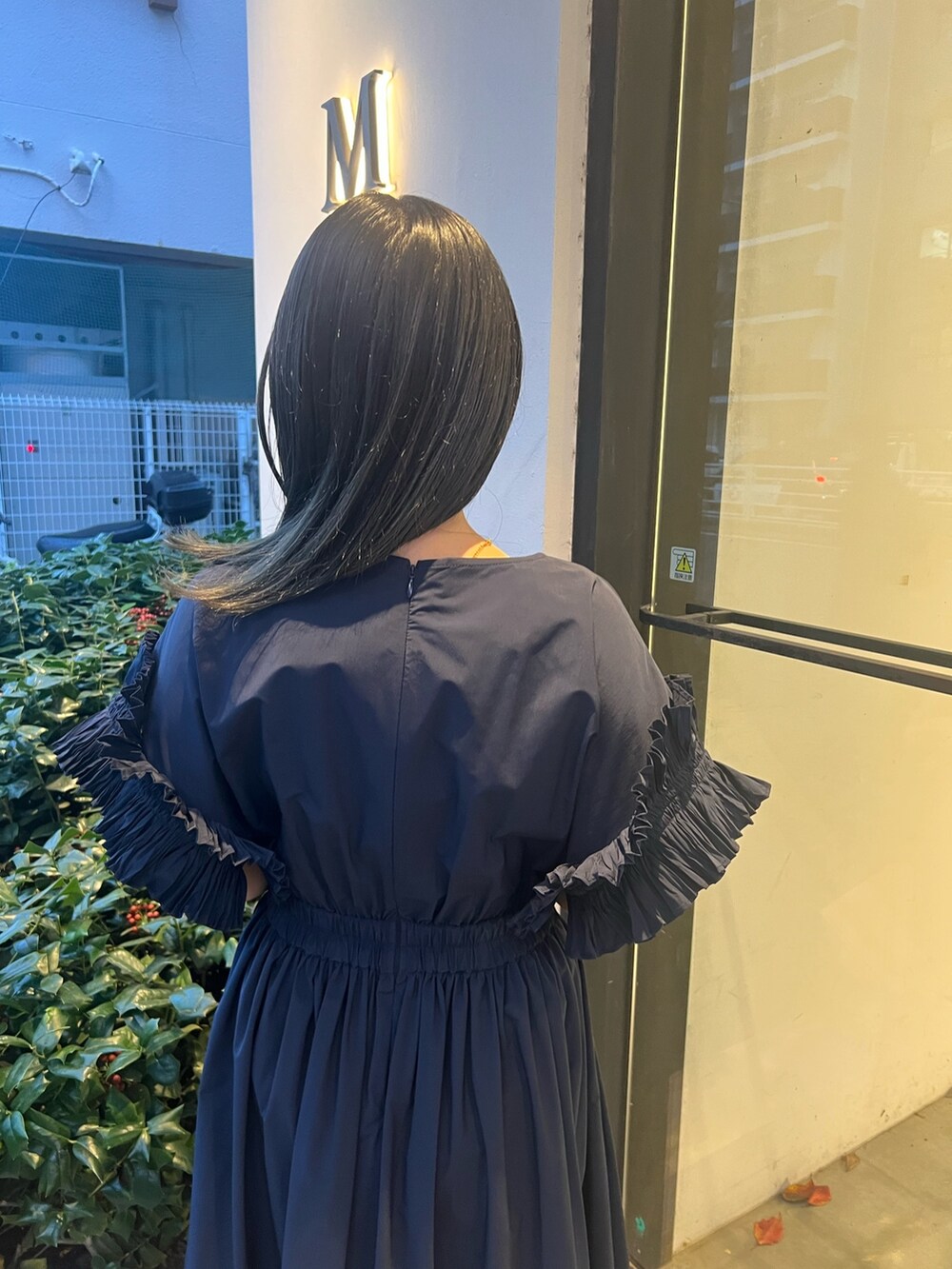ブルー系のワンピース、ベージュ系のハンドバッグを着用したレディースの冬コーディネートの5枚目の写真
