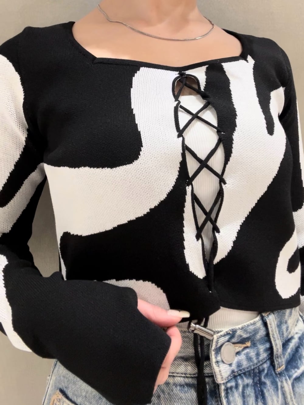 その他のニット/セーター、ホワイト系のキャミソール、ブラック系のショルダーバッグを着用したレディースの冬コーディネートの4枚目の写真