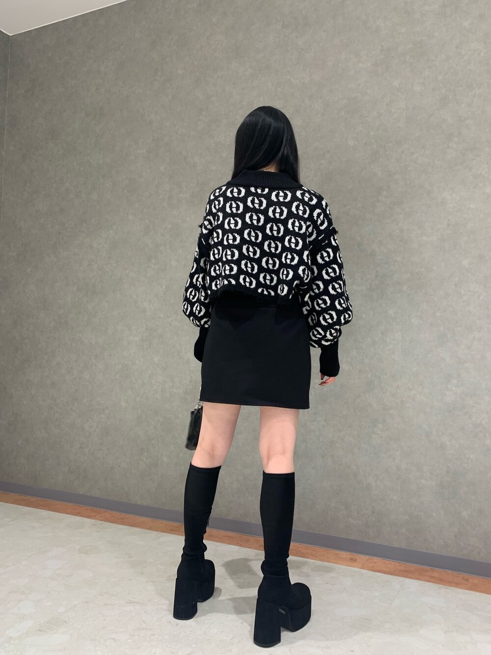 その他のニット/セーター、ブラック系のスカート、ブラック系のブーツを着用したレディースの秋コーディネートの4枚目の写真