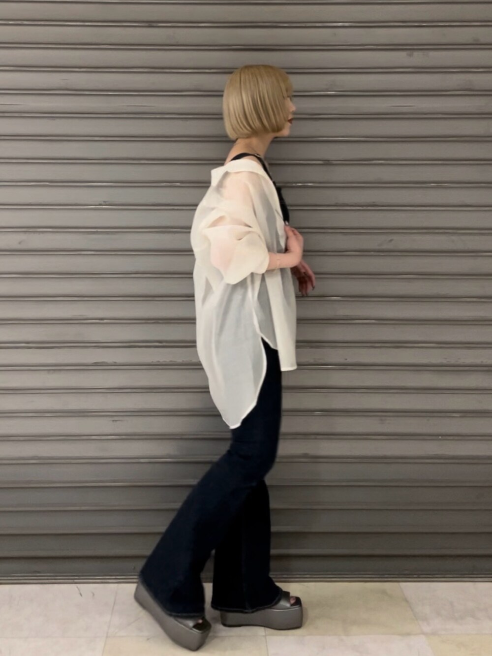 ブルー系のサロペット/オーバーオール、ホワイト系のシャツ/ブラウス、シルバー系のサンダルを着用したレディースの春コーディネートの3枚目の写真