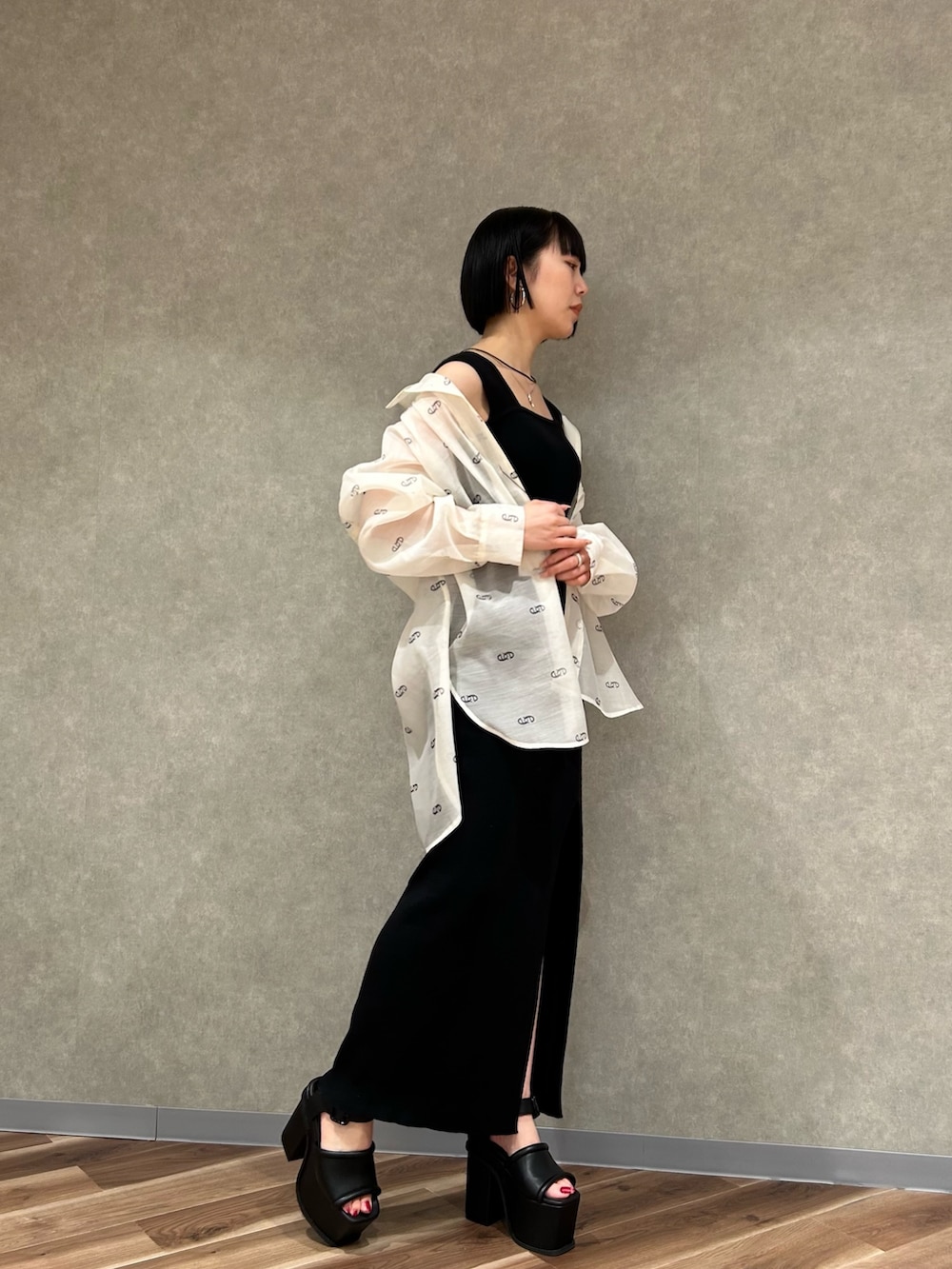 ホワイト系のシャツ/ブラウス、ブラック系のワンピース、ブラック系のサンダルを着用したレディースの春コーディネートの2枚目の写真