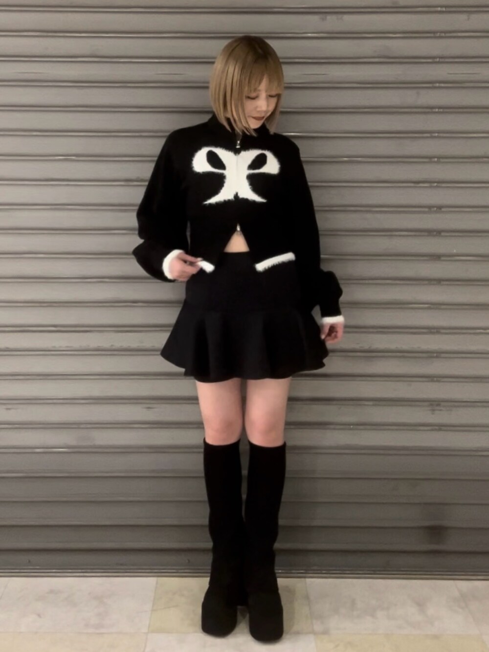 ブラック系のニット/セーター、グレー系のその他アウター、ブラック系のスカートを着用したレディースの冬コーディネートの3枚目の写真