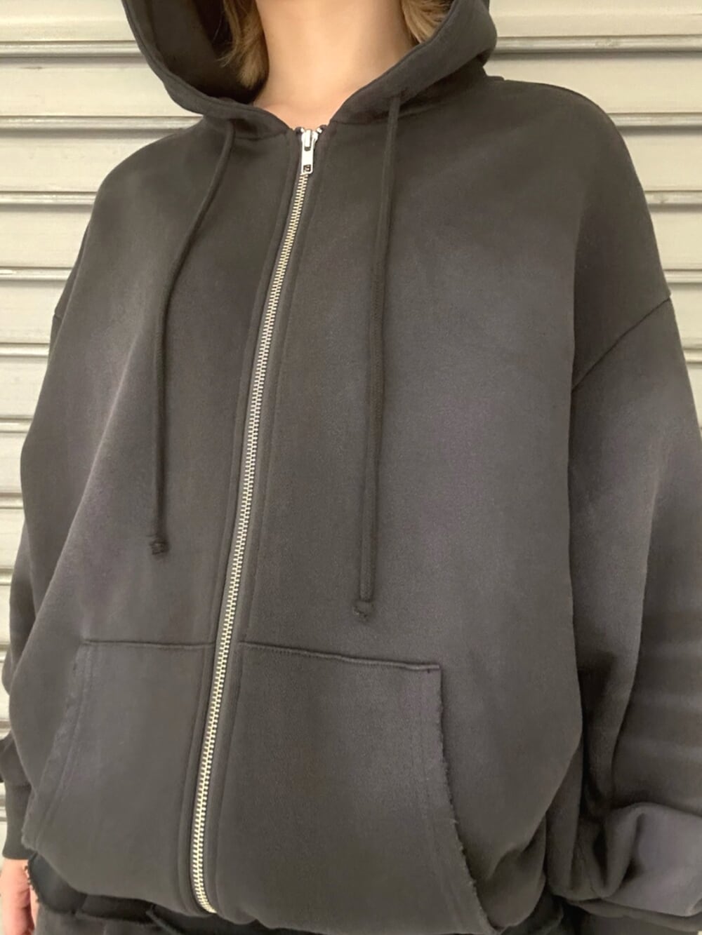 ブラック系のブーツ、グレー系のパーカー、グレー系のスカートを着用したレディースの秋コーディネートの4枚目の写真