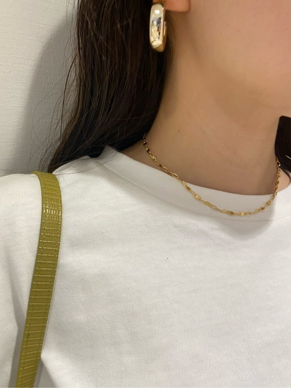 ブラック系のスラックス、ホワイト系のTシャツ/カットソー、イエロー系のショルダーバッグを着用したレディースの春コーディネートの7枚目の写真