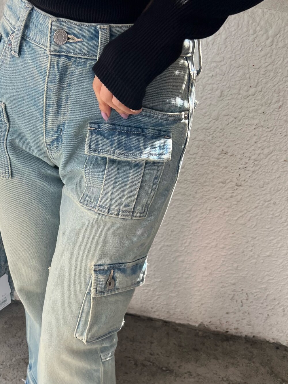 ブルー系のデニムパンツ、ブルー系のショルダーバッグ、ブラック系のTシャツ/カットソーを着用したレディースの冬コーディネートの8枚目の写真