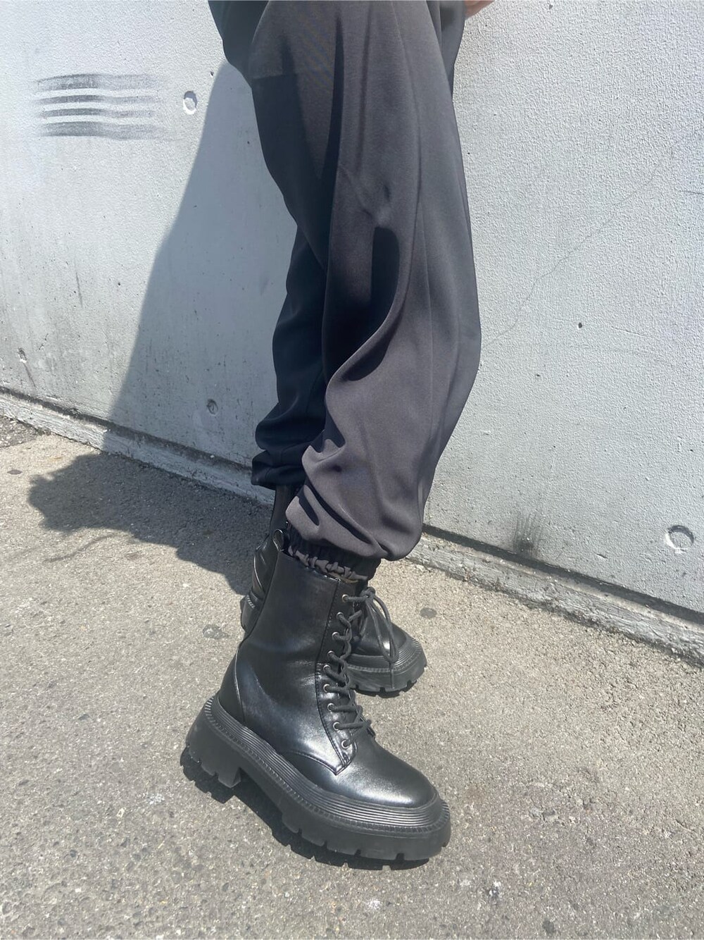 ブラック系のブーツ、グリーン系のニット/セーター、ブラック系のその他パンツを着用したレディースの春コーディネートの8枚目の写真