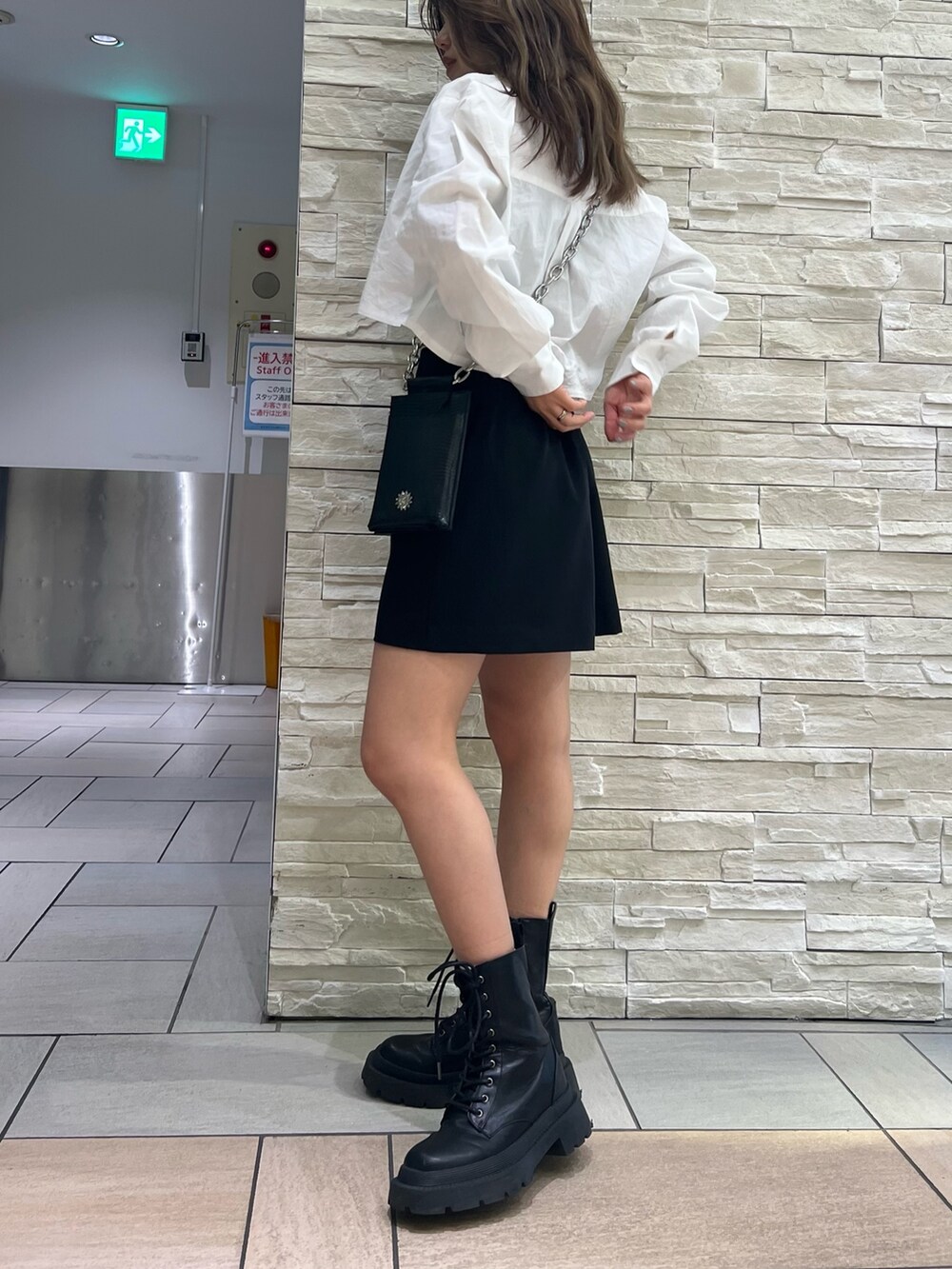 ブラック系のブーツ、ブラック系のスカート、ブラック系のカーディガン/ボレロを着用したレディースの春コーディネートの3枚目の写真