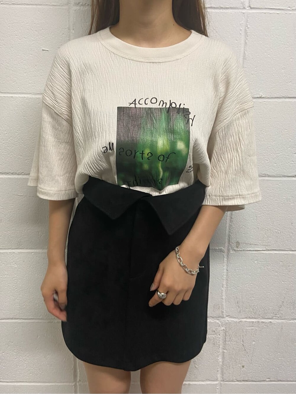 ブラック系のスカート、ブラック系のサンダル、ホワイト系のTシャツ/カットソーを着用したレディースの夏コーディネートの5枚目の写真