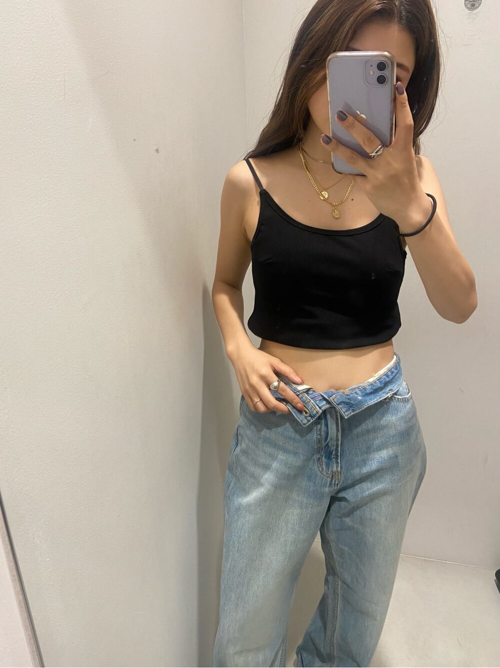 ブラック系のキャミソール、ホワイト系のサンダル、ブルー系のデニムパンツを着用したレディースの夏コーディネートの2枚目の写真