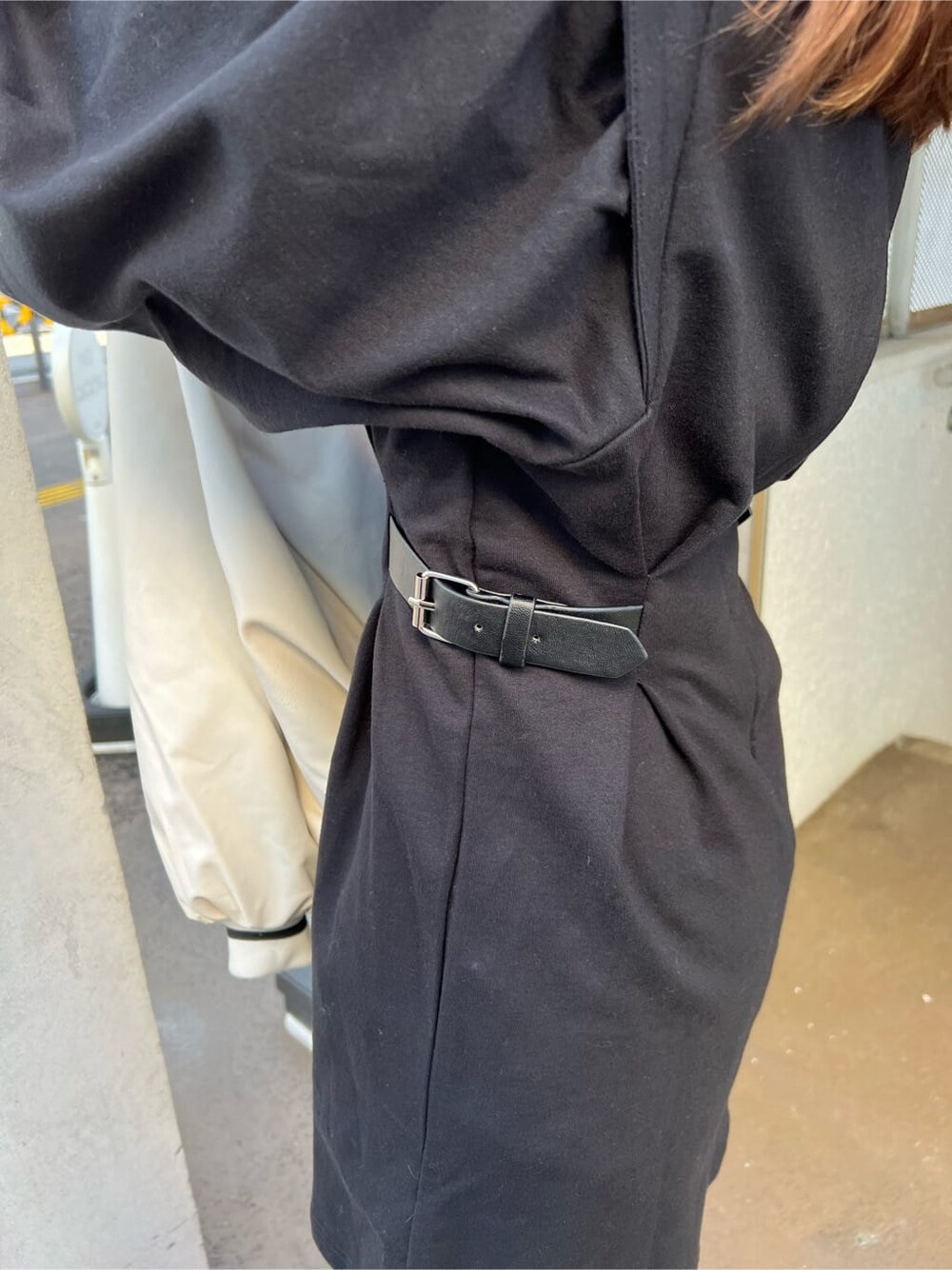 ブラック系のブーツ、ブラック系のワンピース、ホワイト系のスタジャンを着用したレディースの秋コーディネートの5枚目の写真