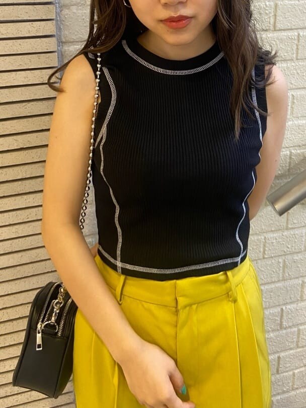 イエロー系のスラックス、ブラック系のショルダーバッグ、ブラック系のサンダルを着用したレディースの春コーディネートの7枚目の写真