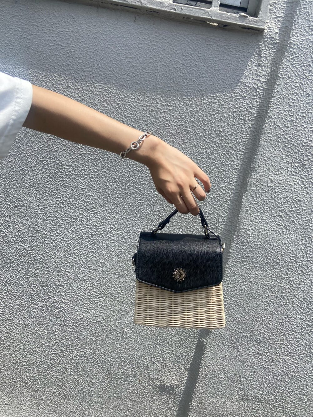 ブラック系のサンダル、ホワイト系のTシャツ/カットソー、ブルー系のデニムパンツを着用したレディースの夏コーディネートの8枚目の写真