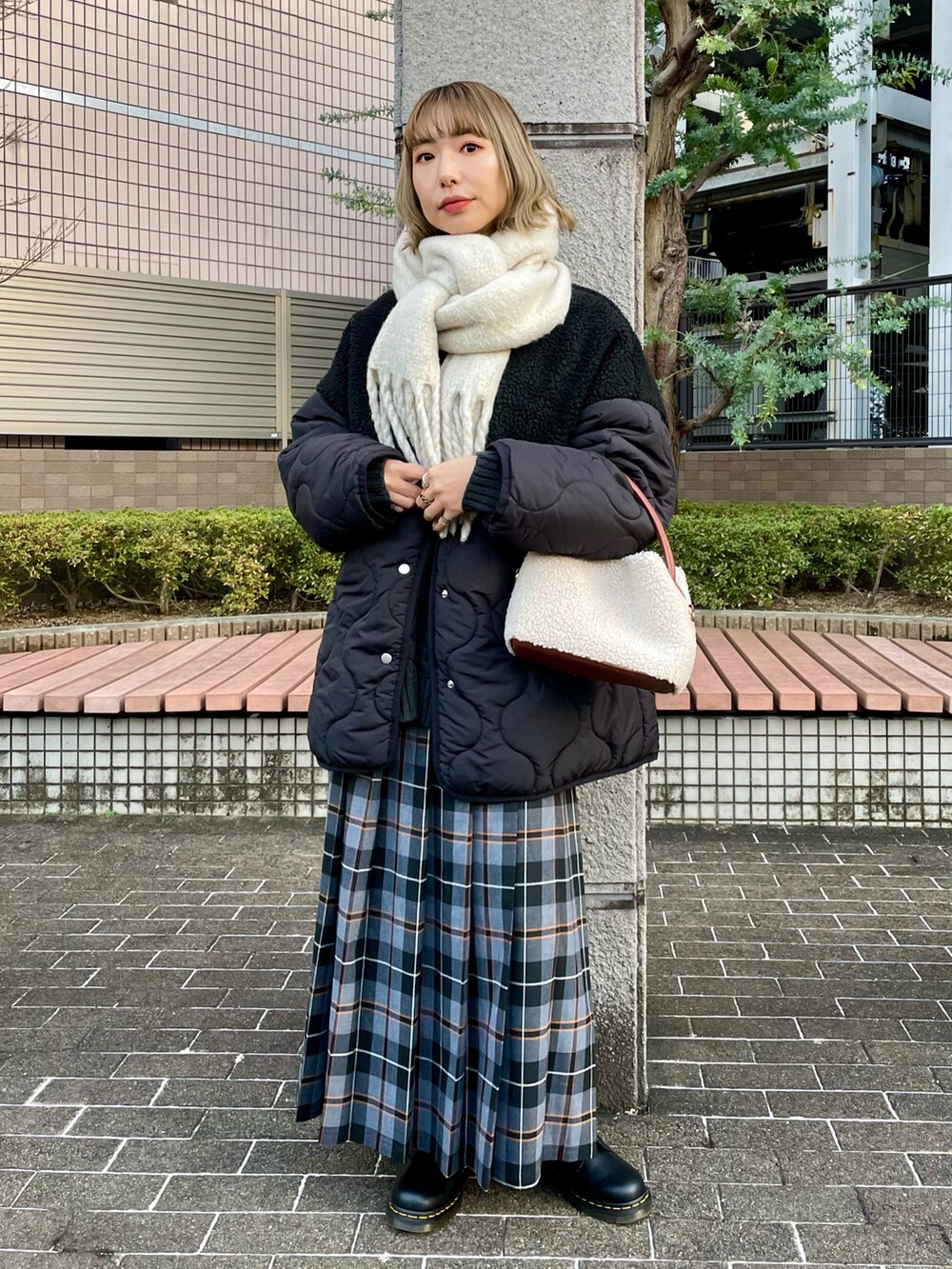 ブラック系のブルゾン、グリーン系のニット/セーター、ホワイト系のTシャツ/カットソーを着用したレディースの冬コーディネートの3枚目の写真