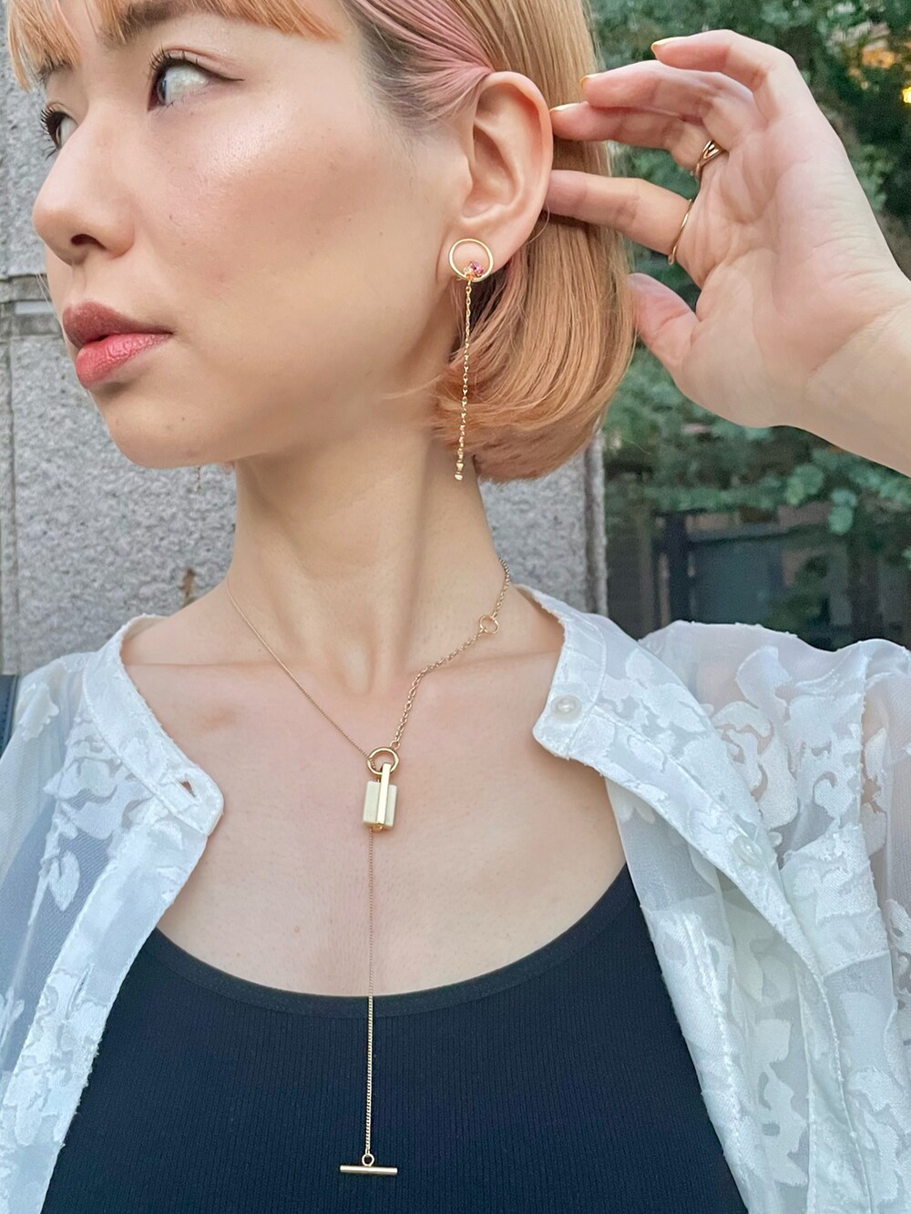 ピンク系のスラックス、ホワイト系のシャツ/ブラウス、ブラック系のキャミソールを着用したレディースの春コーディネートの2枚目の写真