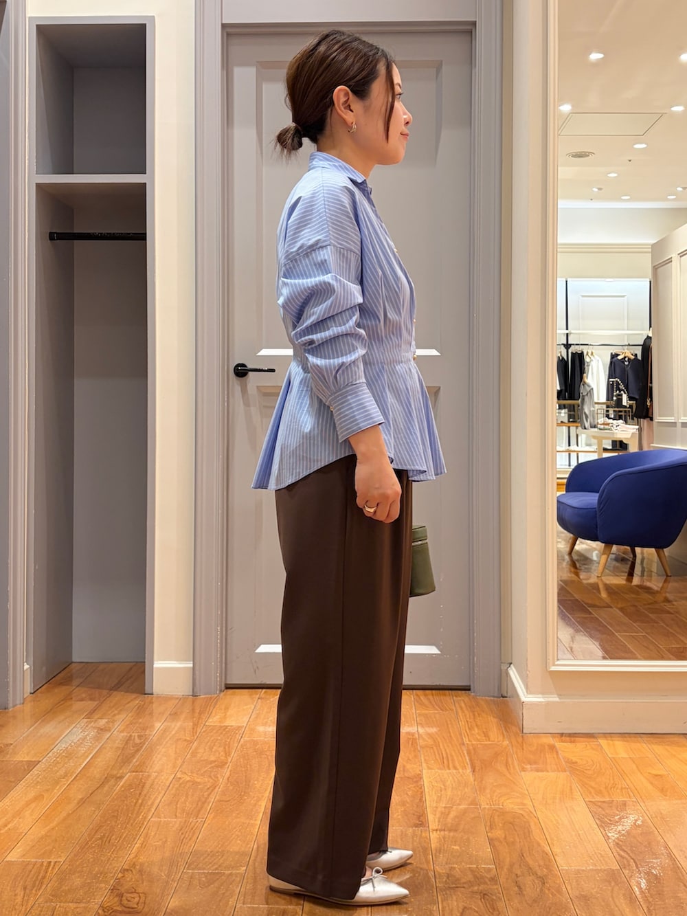ブルー系のシャツ/ブラウス、グリーン系のショルダーバッグ、ブラウン系のその他パンツを着用したレディースの秋コーディネートの3枚目の写真