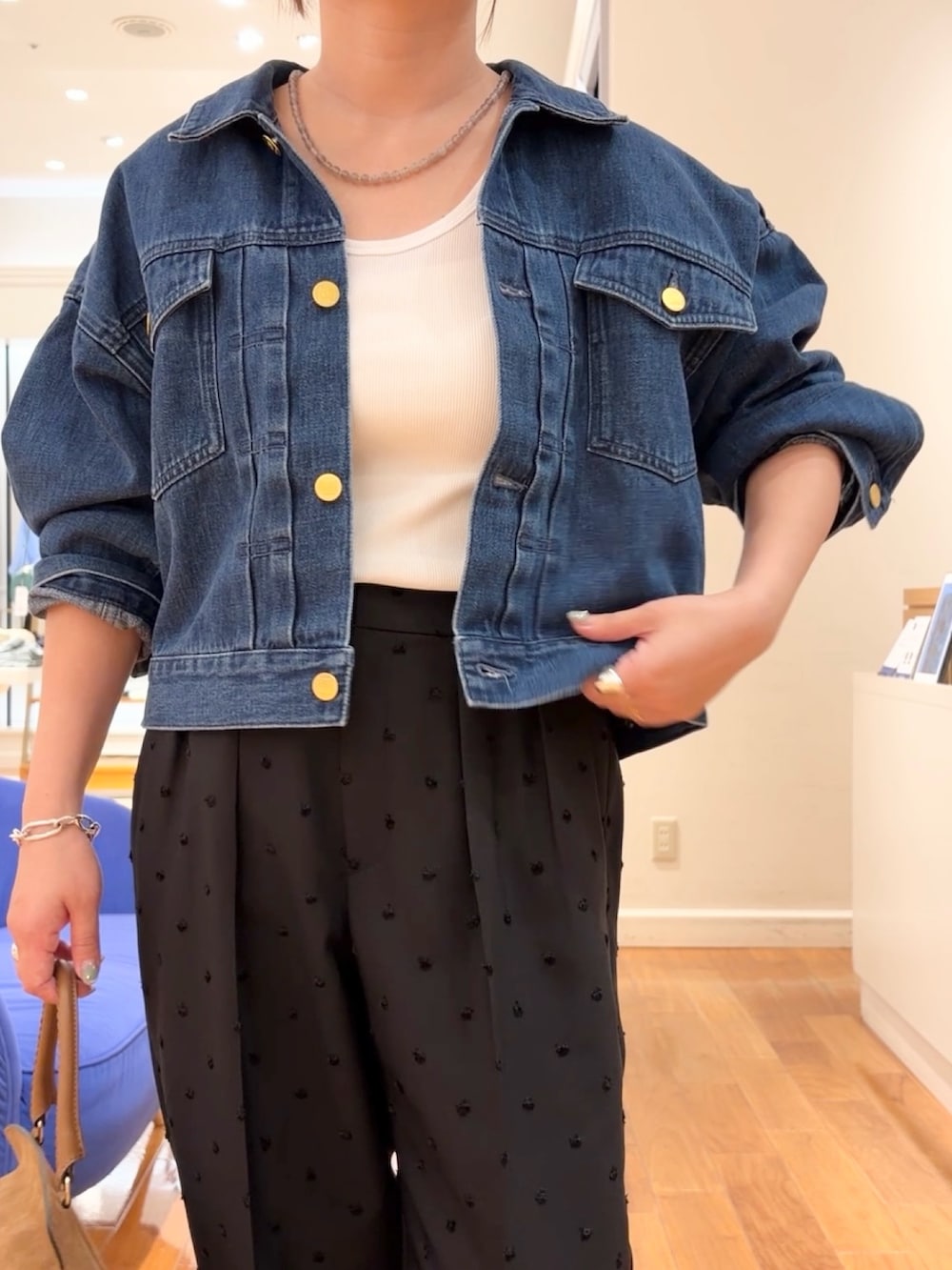 ブラック系のその他パンツ、ブルー系のデニムジャケット、イエロー系のショルダーバッグを着用したレディースの夏コーディネートの3枚目の写真