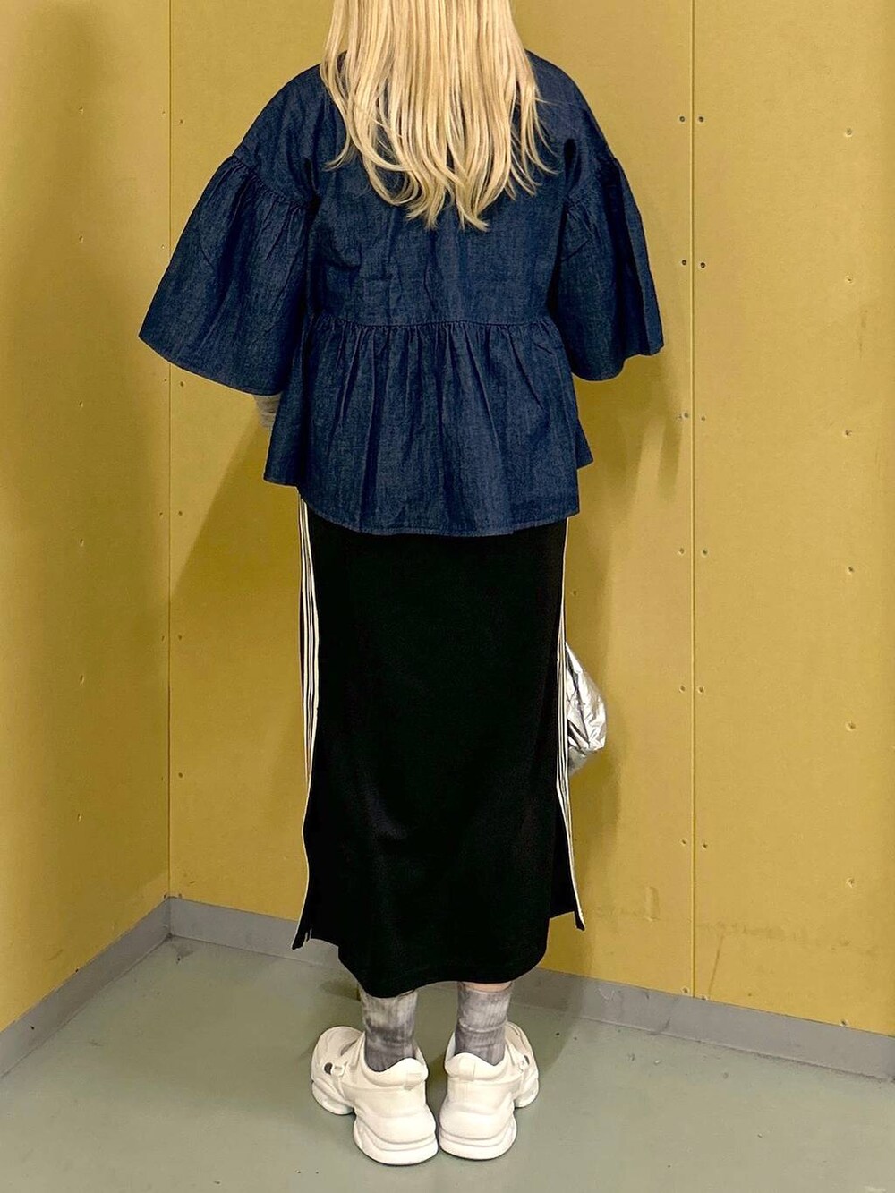 ホワイト系のサンダル、ブラック系のスカート、シルバー系のバックパック/リュックを着用したレディースの春コーディネートの3枚目の写真