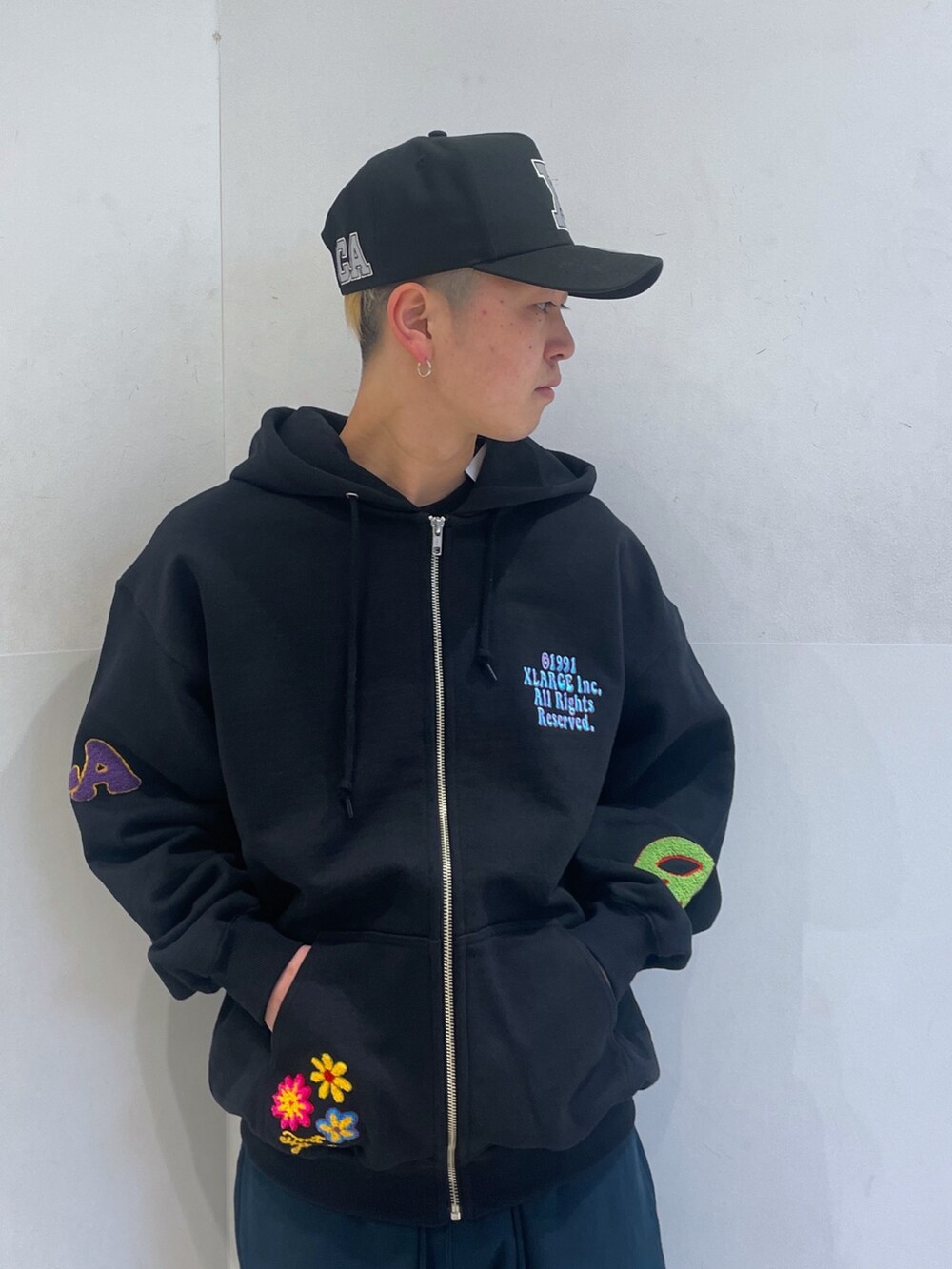 ブラック系のパーカー、ブルー系のスウェットパンツを着用したメンズの春コーディネートの5枚目の写真