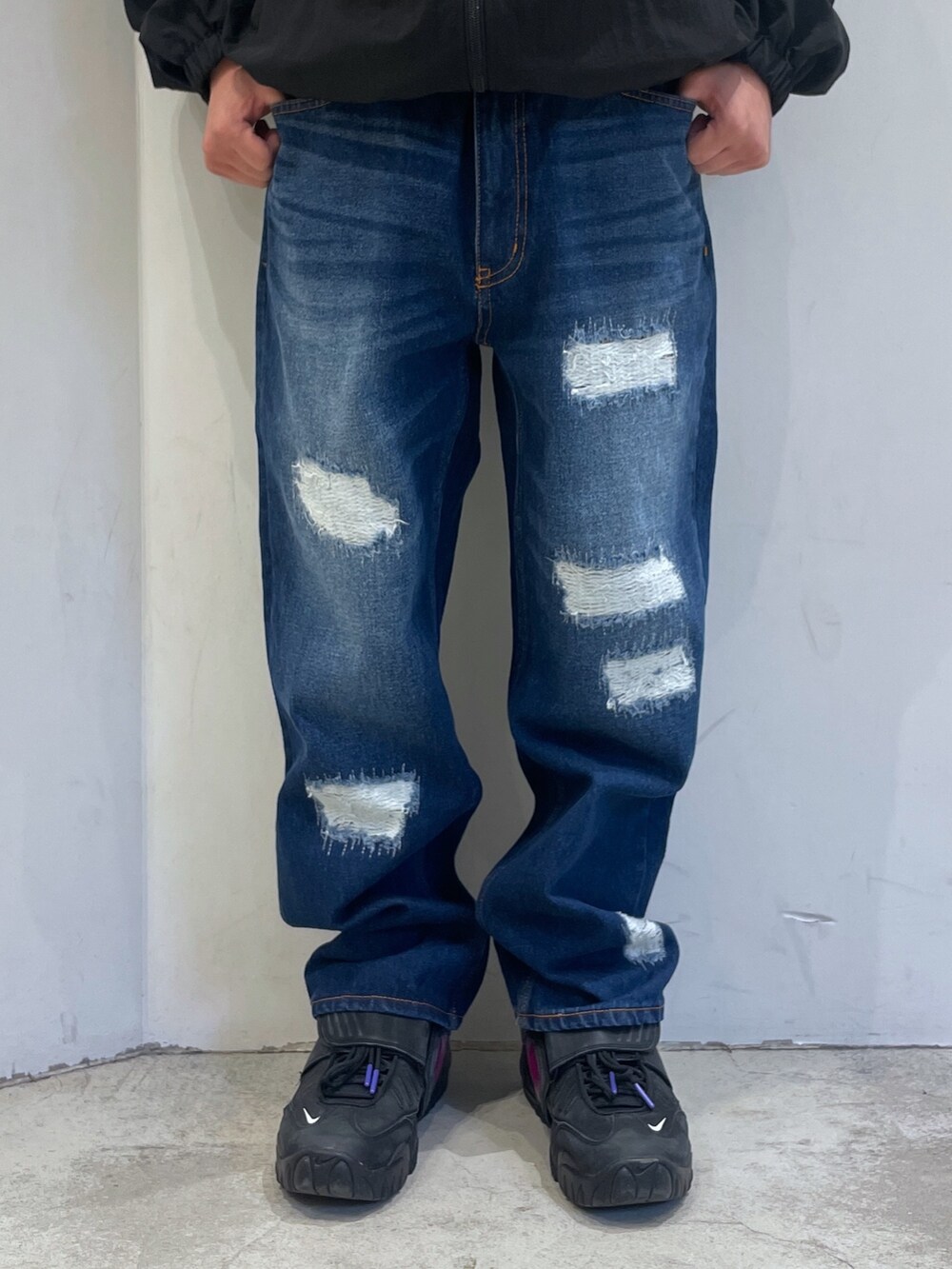 ブラック系のナイロンジャケット、ブルー系のデニムパンツを着用したメンズの冬コーディネートの6枚目の写真