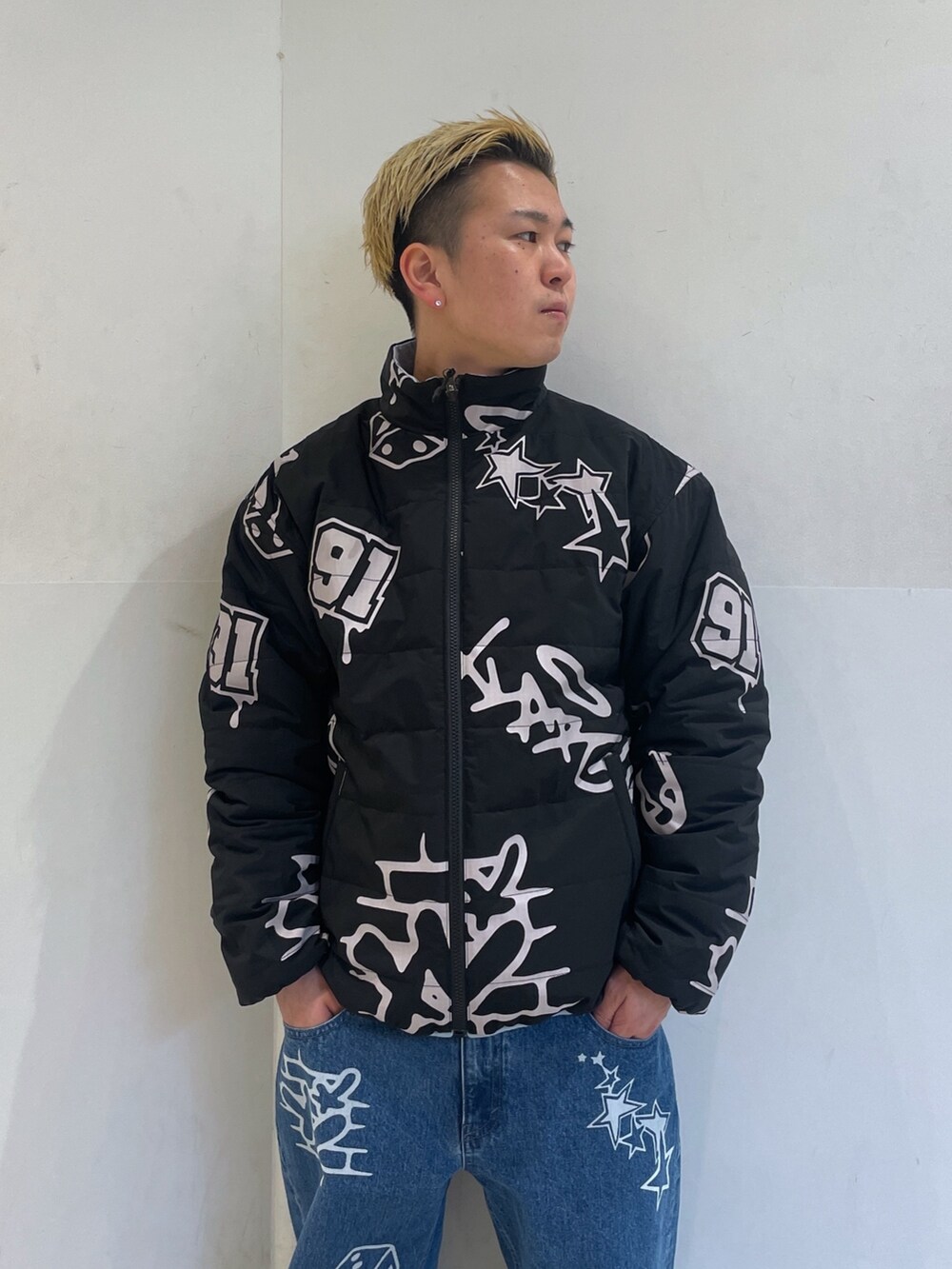 ブラック系のダウンジャケット/コート、ブルー系のデニムパンツを着用したメンズの冬コーディネートの5枚目の写真