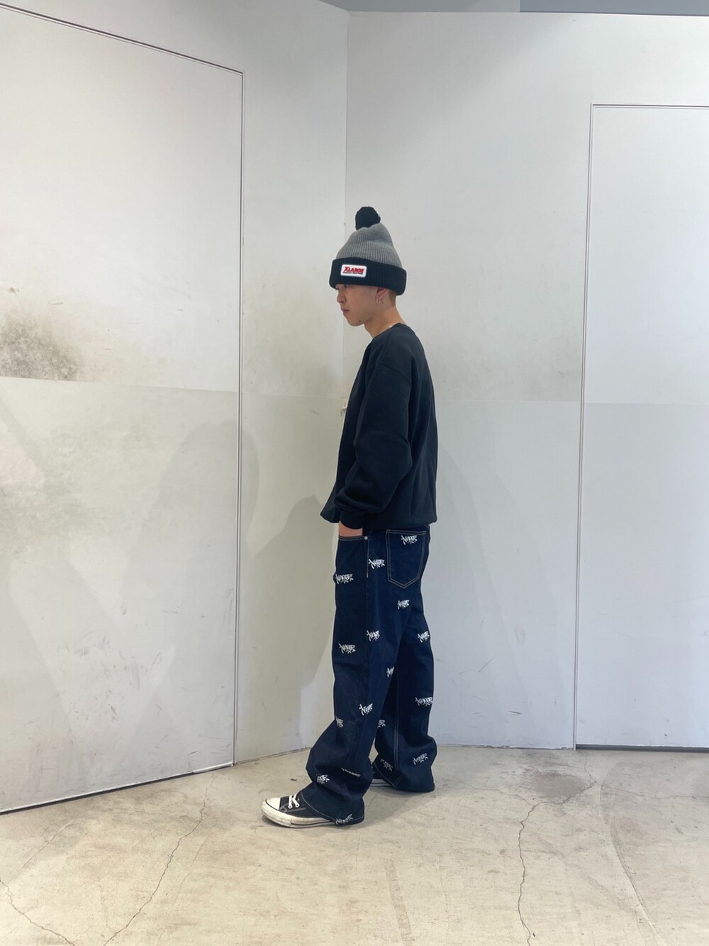 ブラック系のスウェット、ブルー系のデニムパンツ、グレー系のニットキャップ/ビーニーを着用したメンズの秋コーディネートの5枚目の写真