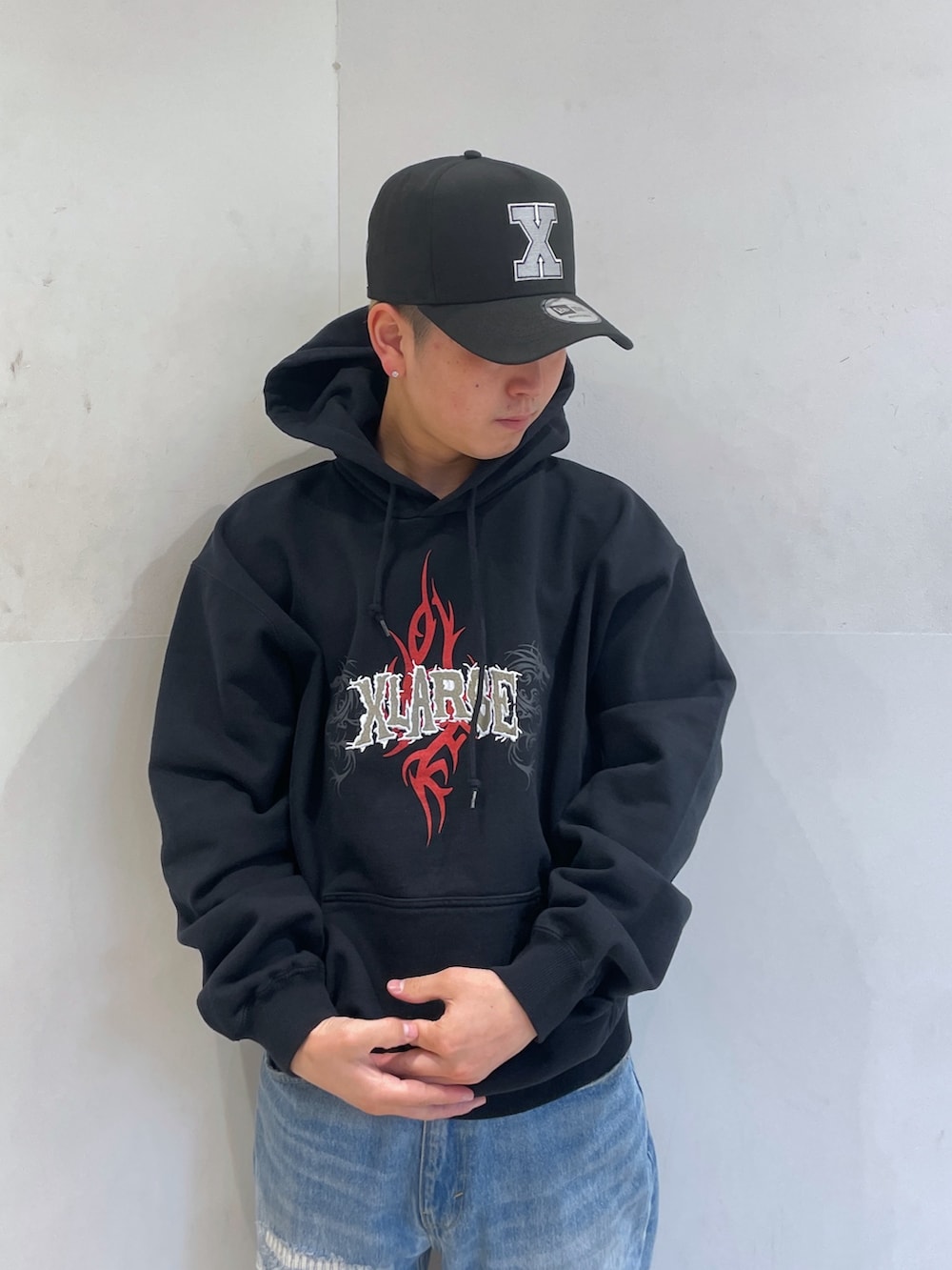 ブラック系のパーカー、ブルー系のデニムパンツを着用したメンズの冬コーディネートの5枚目の写真