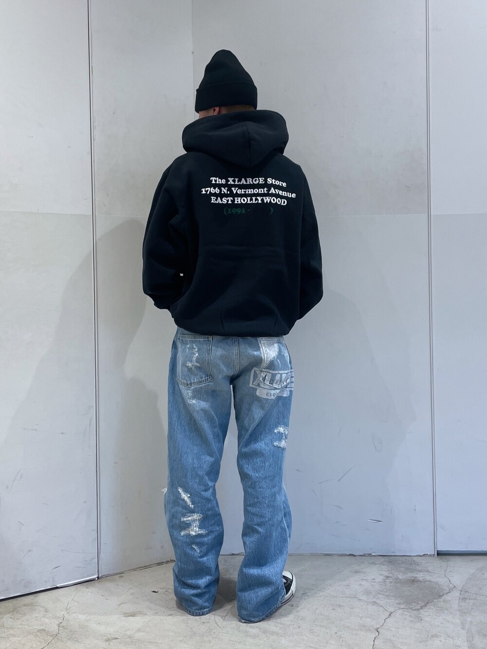 ブラック系のパーカー、ブルー系のデニムパンツ、ブラック系のニットキャップ/ビーニーを着用したメンズの秋コーディネートの4枚目の写真