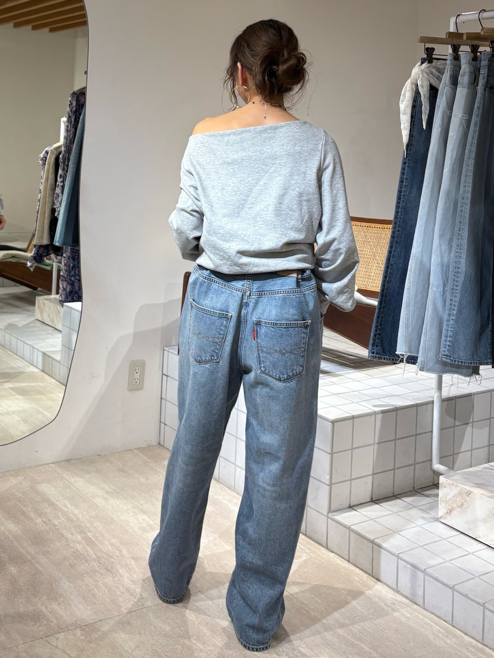 グレー系のTシャツ/カットソー、ブルー系のデニムパンツを着用したレディースの冬コーディネートの2枚目の写真